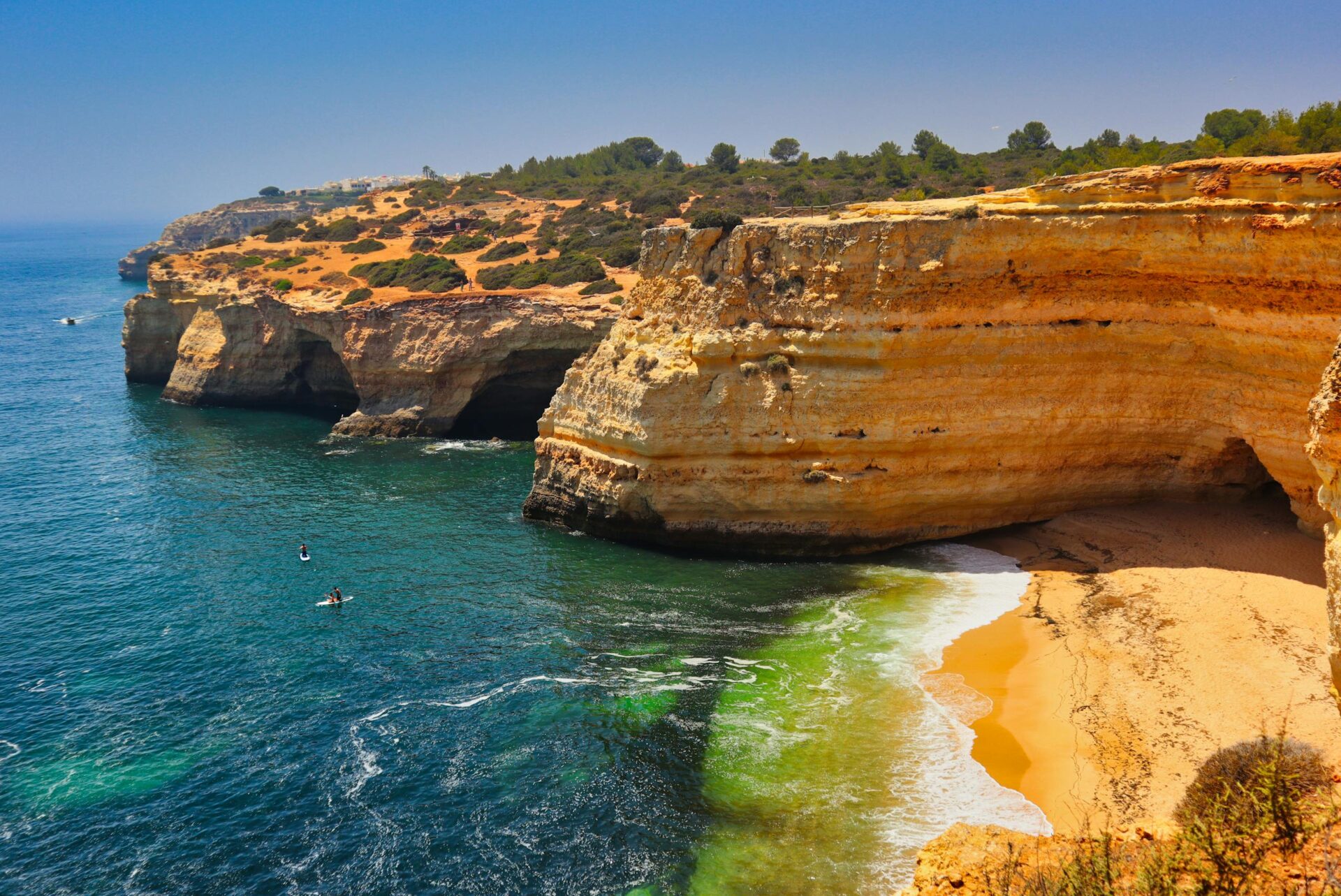 A breathtaking aerial view of Algarve cliffs and turquoise waters in Portugal's Praia de Corredoura.