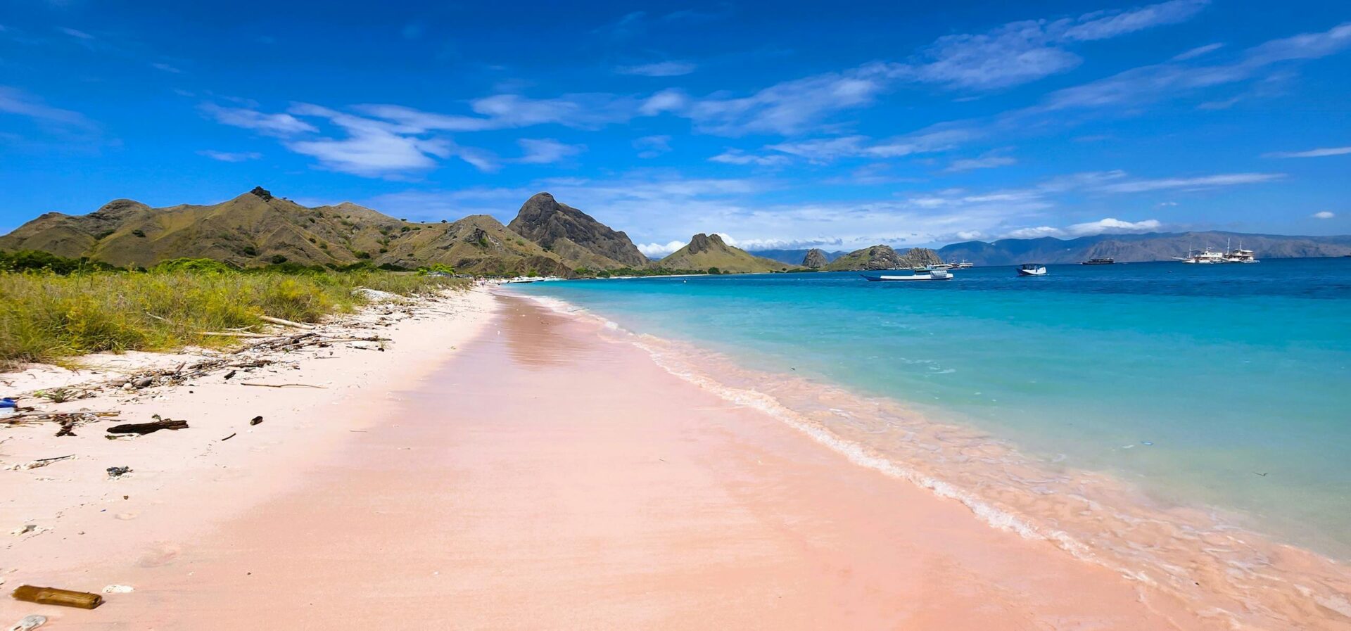 Explore the stunning pink sand and turquoise waters at Padar Island in Komodo National Park, Indonesia.