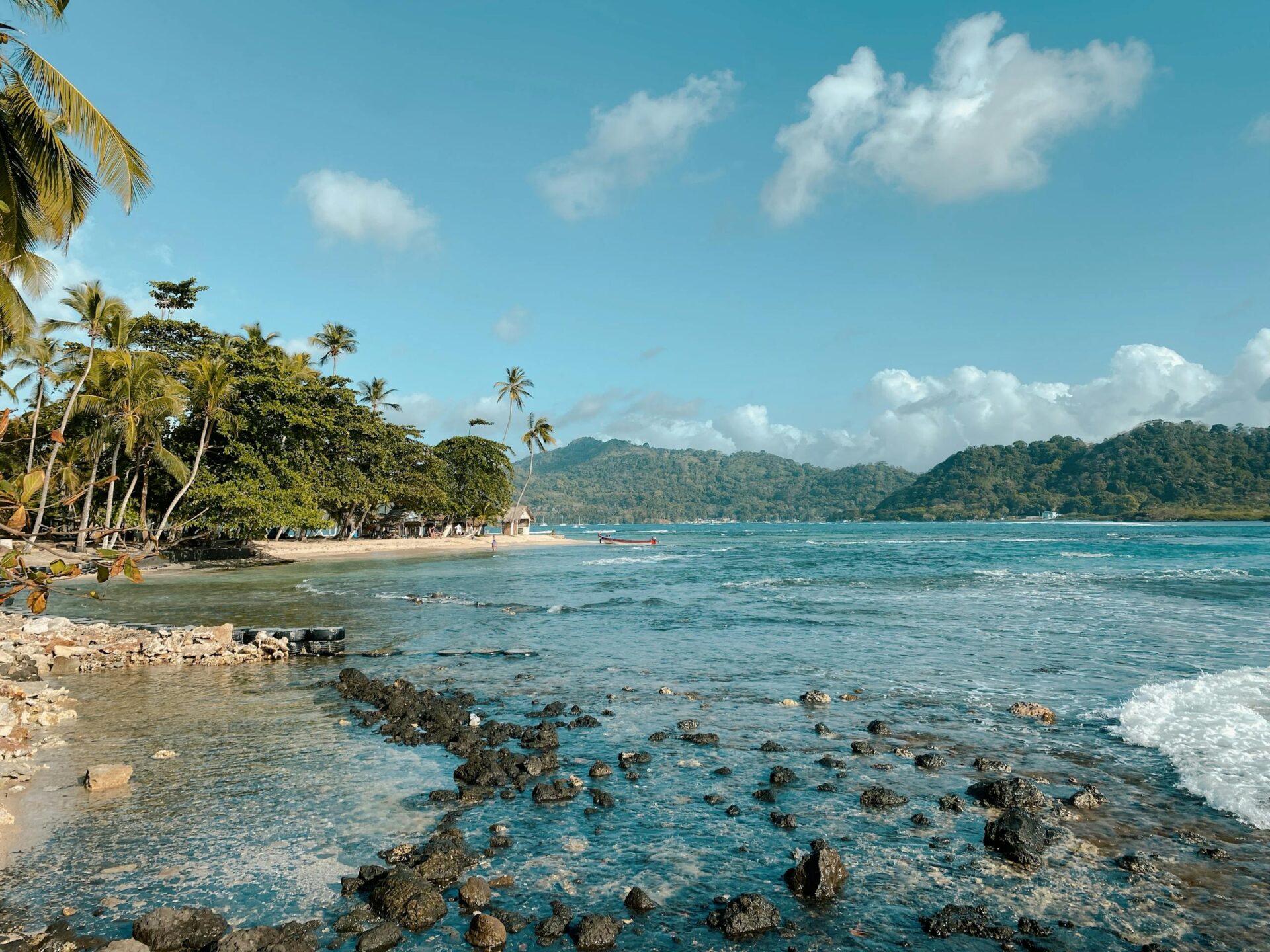 Explore the tranquil beauty of Colón's pristine beach, surrounded by lush greenery.