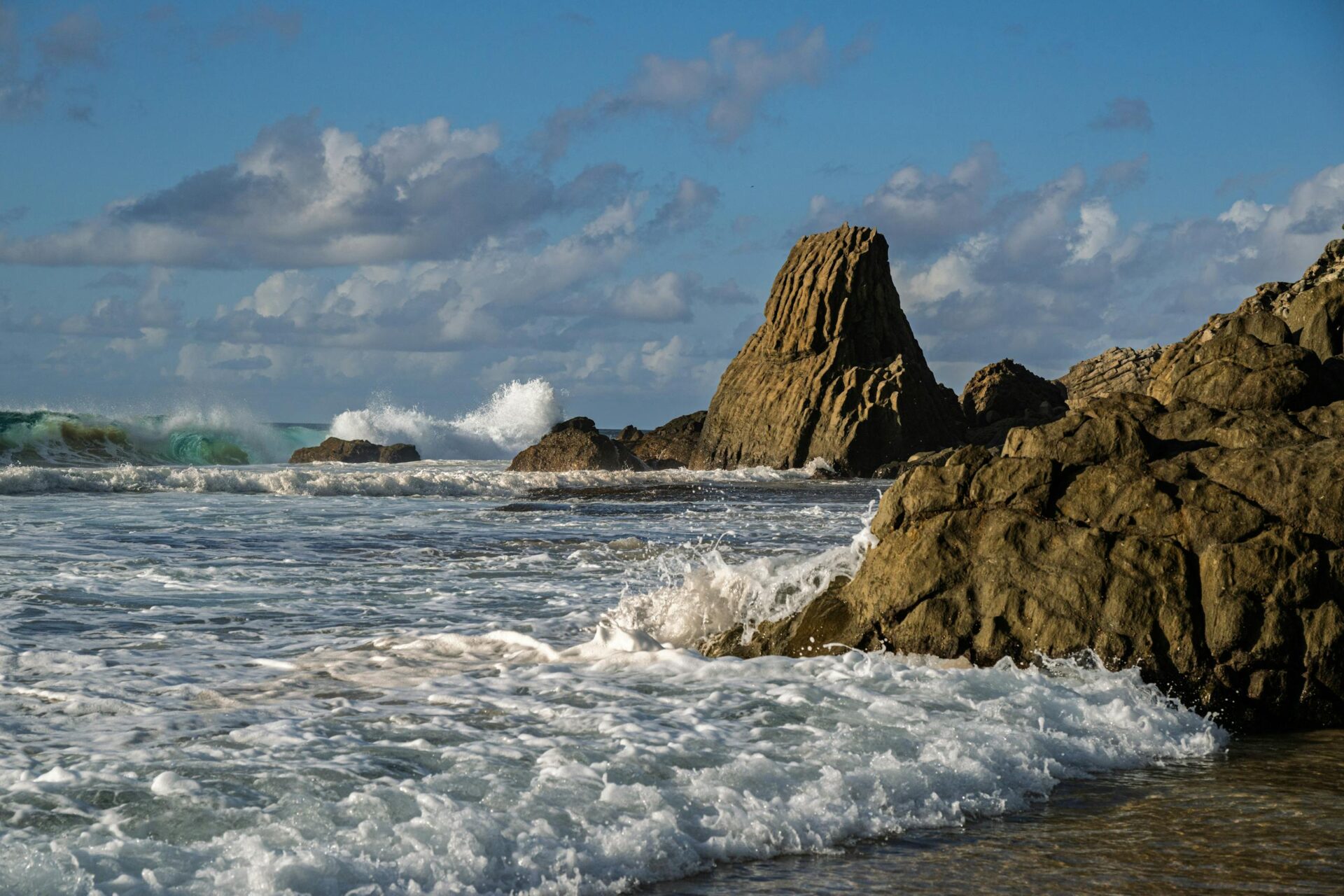 View of powerful waves crashing against rocky coast at Praia dos Carneiros, Pernambuco.